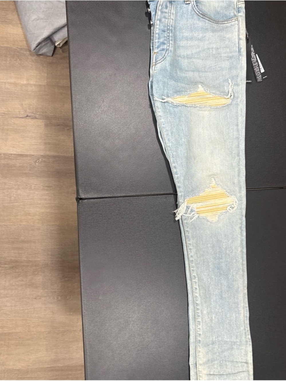 AMIRI Light Blue Distressed Skinny Jeans with Yellow Patch Accents